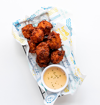 Picture of Biscuit Belly appetizer of loaded tots with sweet maple mayo sauce