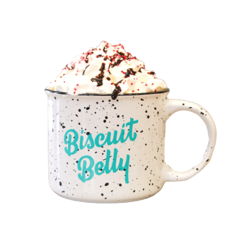 A biscuit belly mug filled with our cupid's cup latte, topped with whipped cream, a chocolate drizzle, and colorful, Valentine sprinkles.