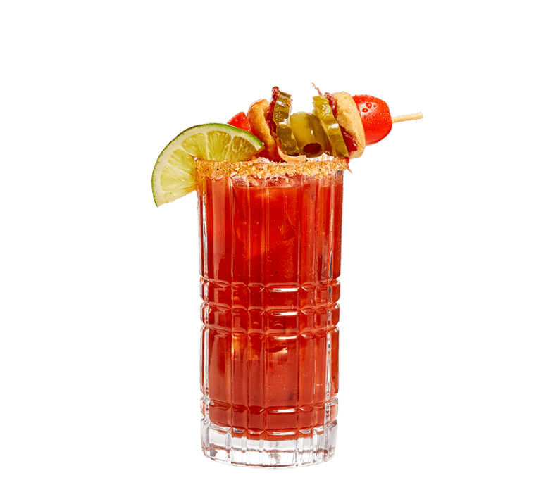 high ball class rimmed with biscuit belly seasoning, filled with spicy bloody mary mix and vodka, and topped with a half lime slice & a wooden skewer with a cherry tomato, mini biscuit, bacon, a belly pickle, and a green olive on it