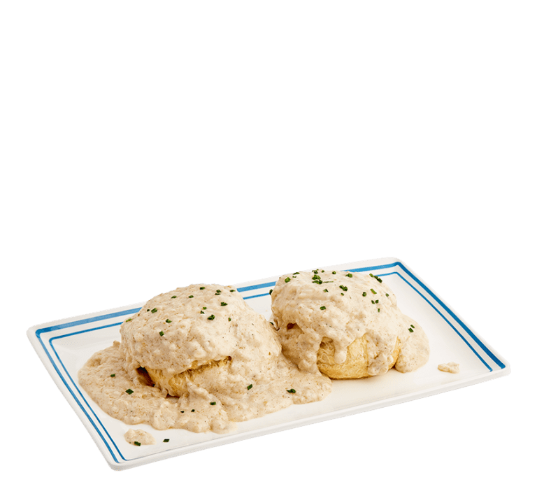 two biscuits topped with sausage gravy on a white plate with a blue border