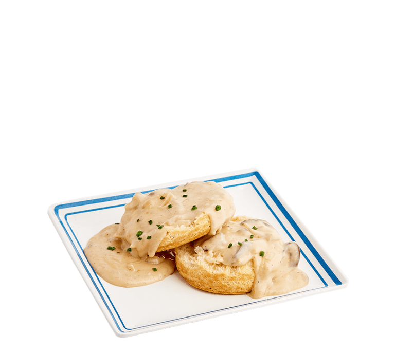 a single open-faced biscuit topped with a mushroom gravy and chopped green chives on a white plate with a blue boarder