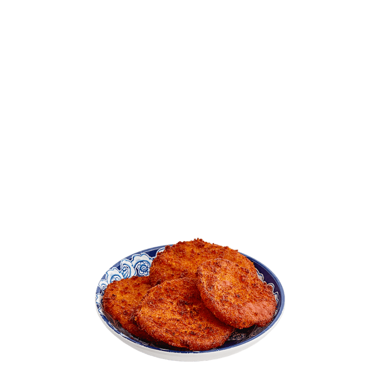 four fried green tomatoes stacked in a small blue bowl
