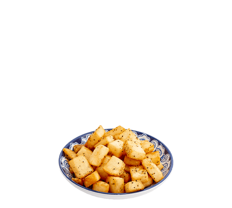 fried diced potato pieces seasoned with salt and pepper in a small blue bowl